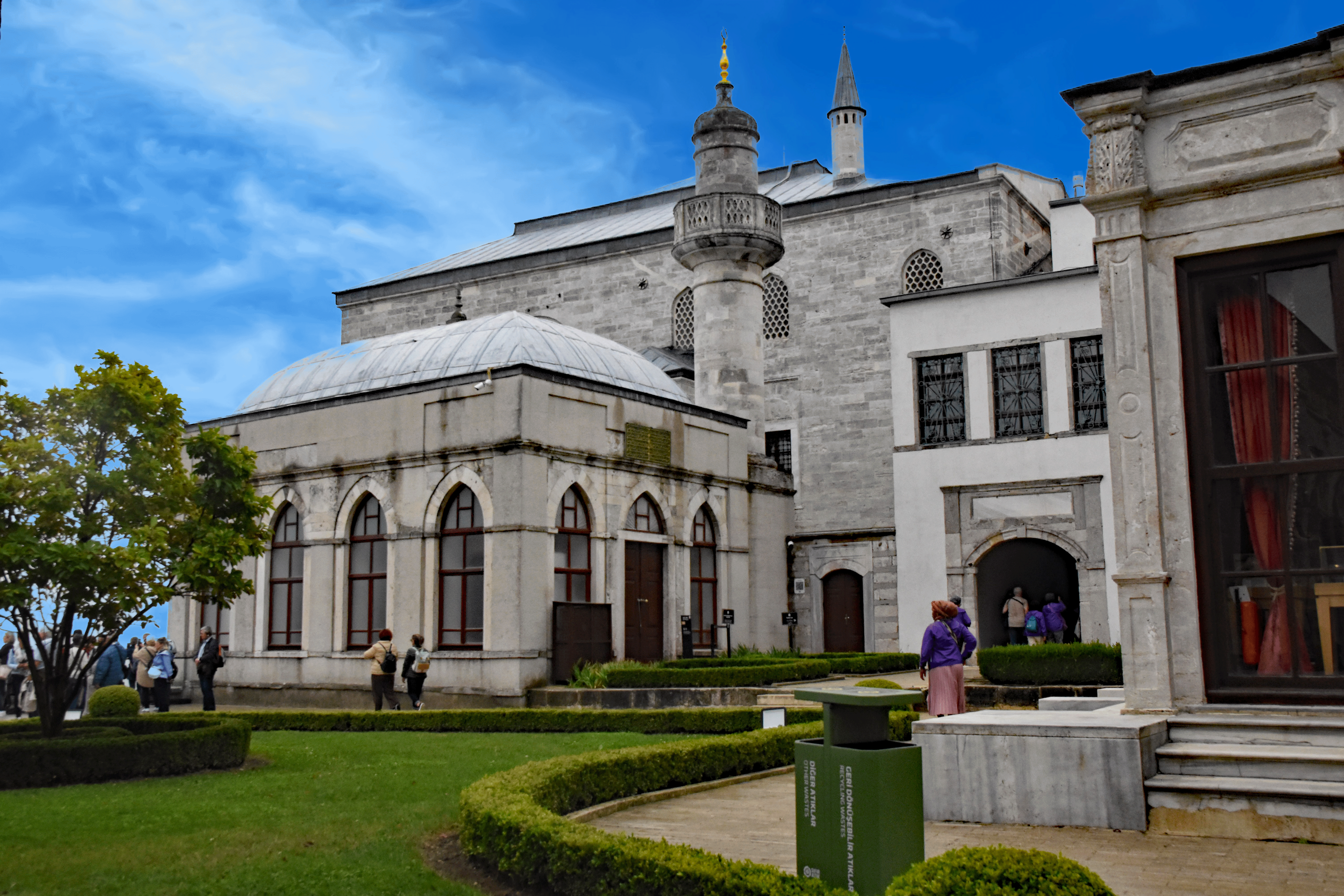 Exterior view of Topkapi Palace featuring architectural details and greenery in the foreground.